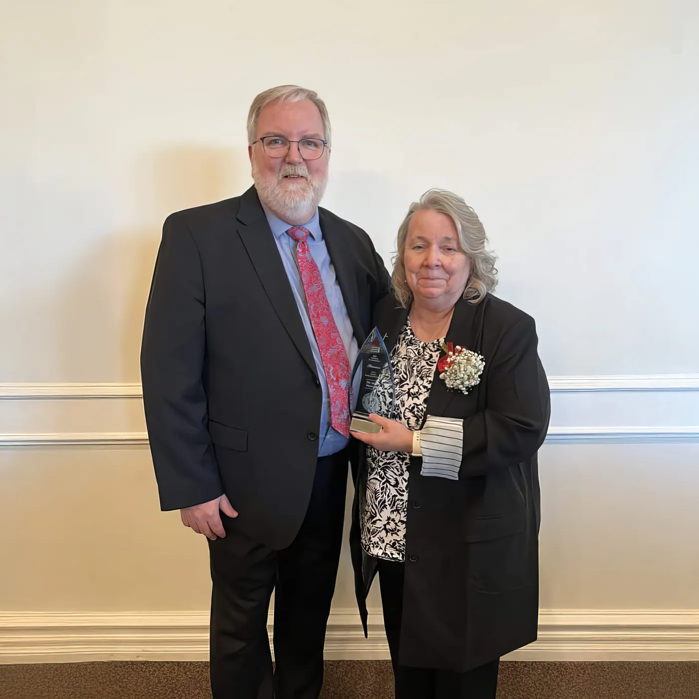 Dr. Mary Frintner standing with a guest at a recognition event