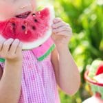 child eating a watermelon