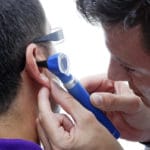 audiologist looking in an ear