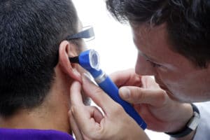 audiologist looking in an ear