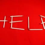 Red flag with help spelled out with matches